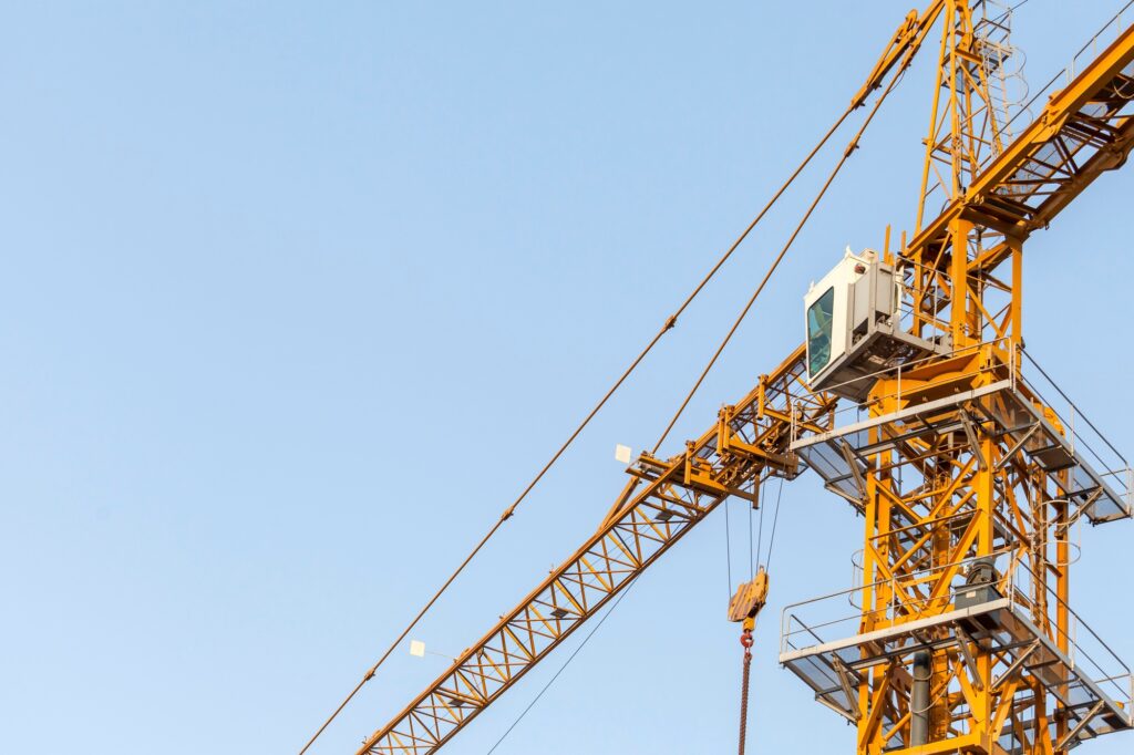 Construction crane against the blue sky
